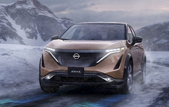 Nissan ARIYA in Sunrise Copper on snowy mountain road | Mountain View Nissan of Chattanooga in Chattanooga TN